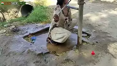 Young village school girl taking a bath in a sari and caught on camera