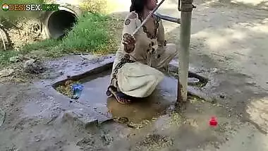 Young village school girl taking a bath in a sari and caught on camera