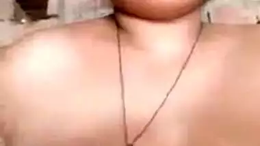 Older Indian widow winks whilst engulfing own large boobs