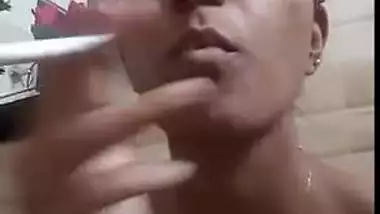 Nude Indian XXX girl smoking and showing her tits and cunt on selfie cam
