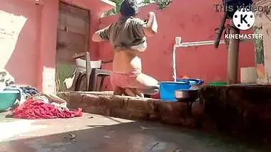 Big boobs wife washing clothes on outdoor