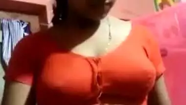 Aroused Desi wife slowly takes red top off to expose boobs for XXX fans