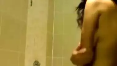 Indian girl takes her clothes off and gets into the shower stall for some porn